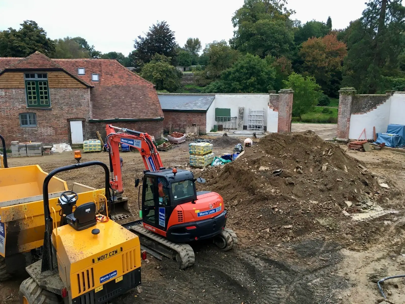 Level concrete foundation slab for a home extension in Hastings, with the first rows of brickwork beginning.