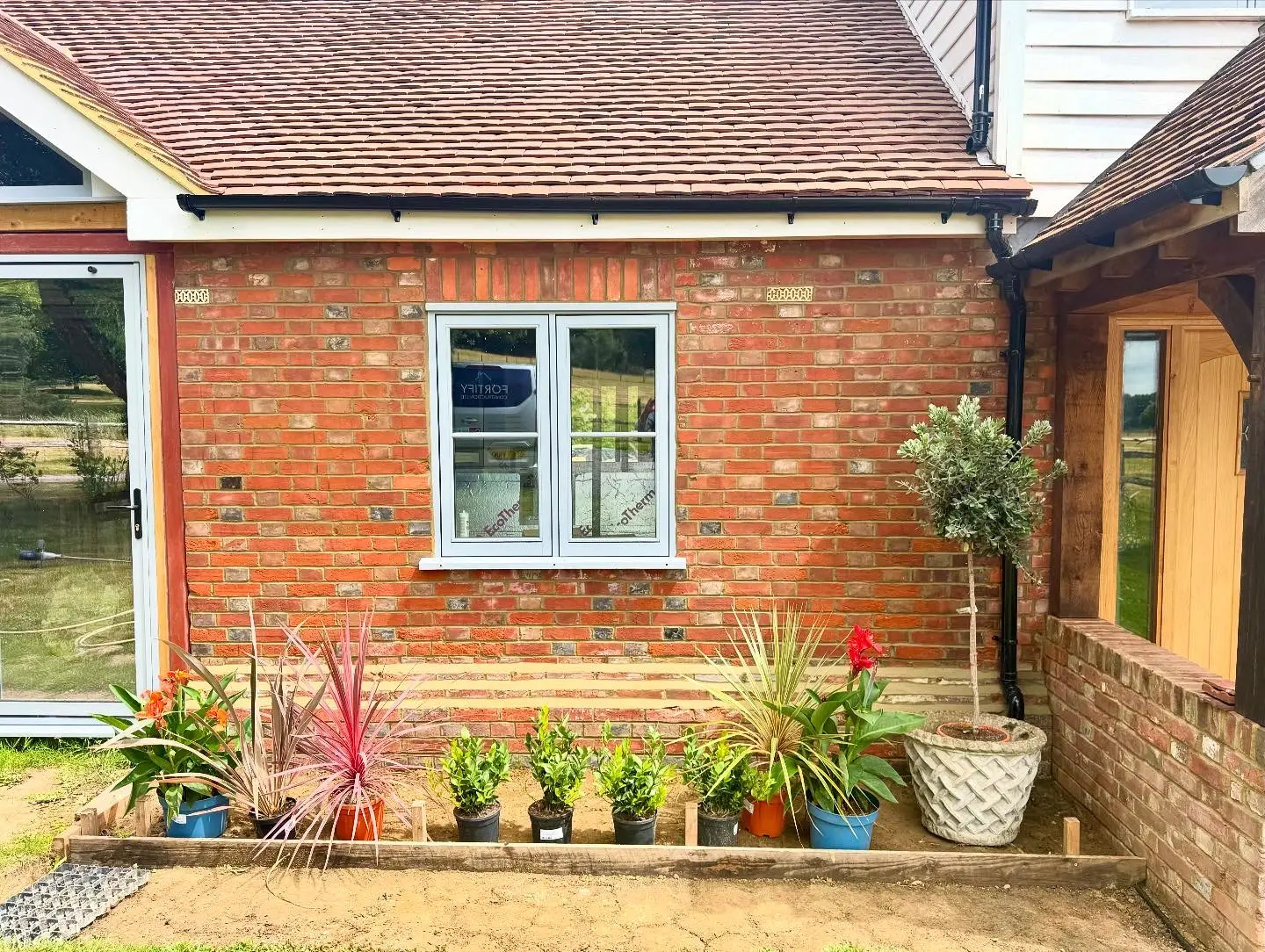 A restored Flemish bond brick wall in Tenterden featuring traditional lime mortar and Wealden clay bricks.