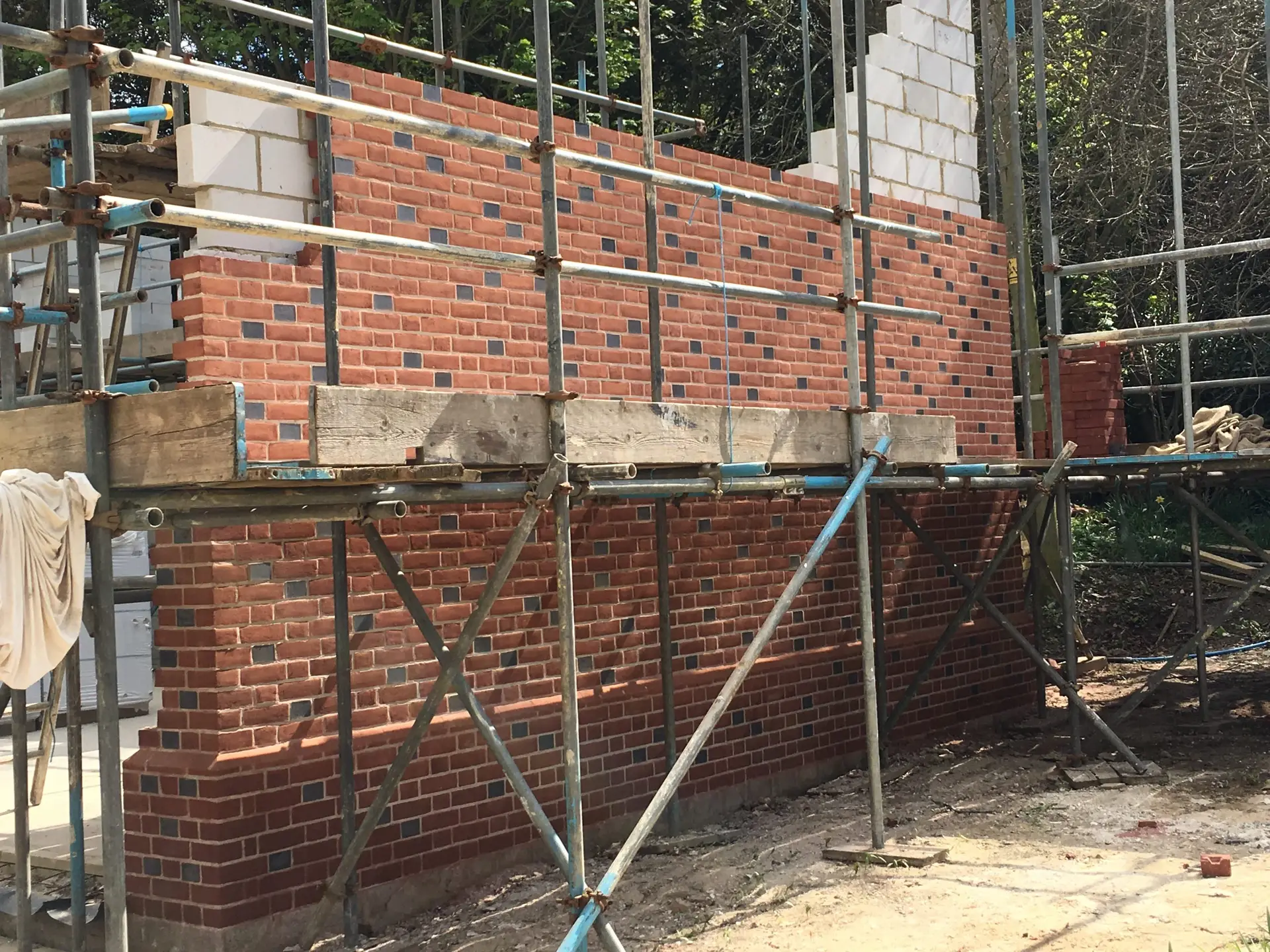 Close-up of rainwater soaking into cracked mortar joints in traditional Kent brickwork.