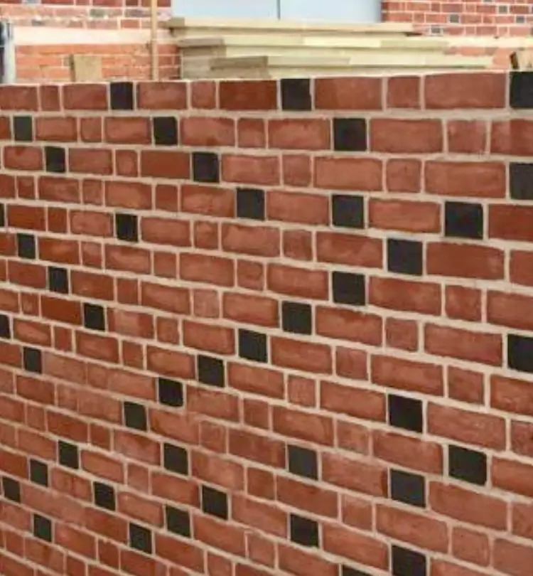 Close-up of breathable lime mortar texture on a traditional 19th-century heritage brick wall.