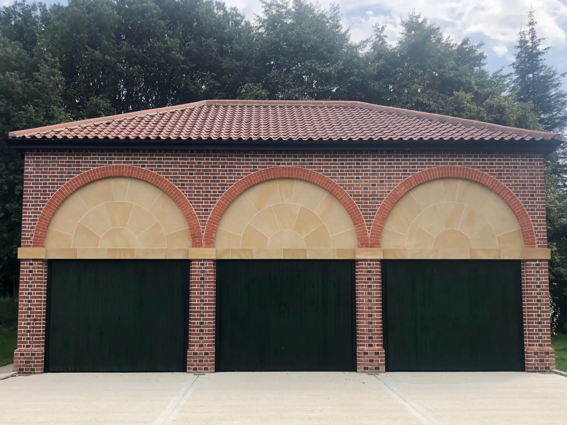 A beautifully constructed garden wall and patio area, showing how quality brickwork integrates with a landscaped space.