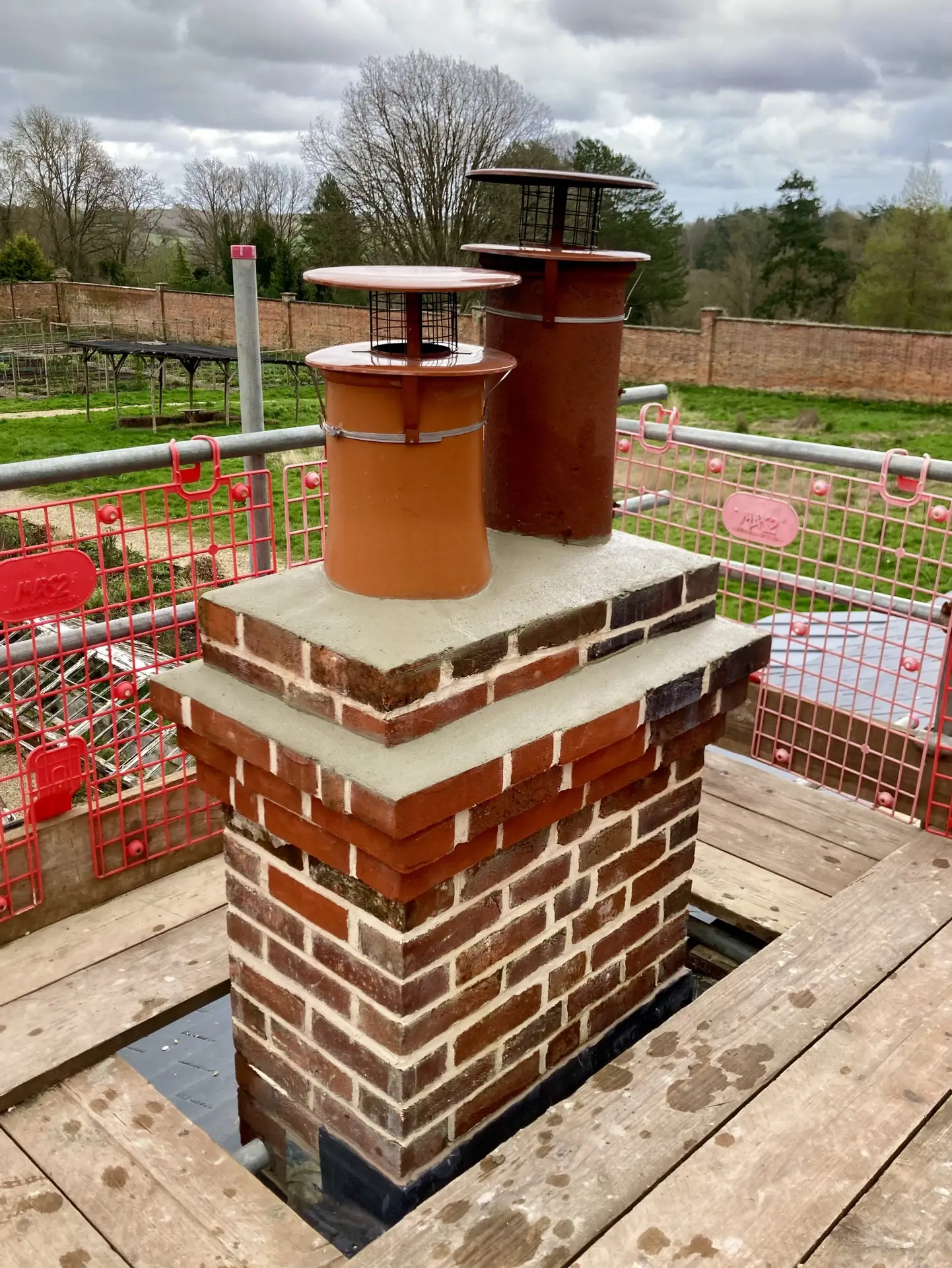 A professional mason carefully repairing a chimney, demonstrating the precision and care required for lasting masonry work.