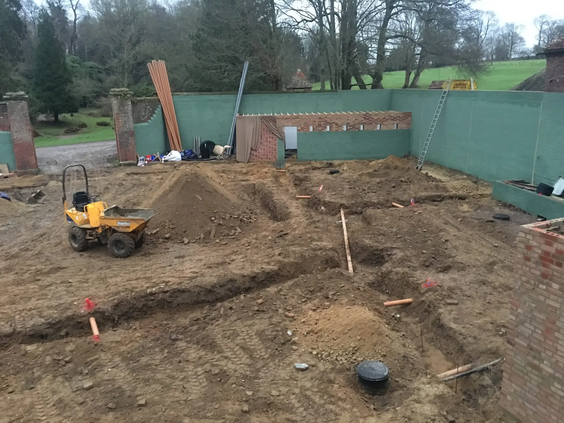 New drainage and utility pipe installation within a professionally prepared groundworks trench in East Sussex.